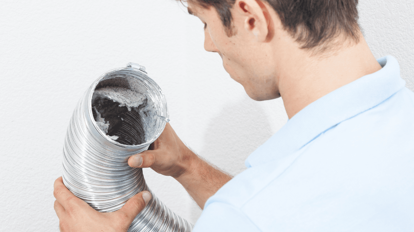 man checking dryer vent cleaning for safety